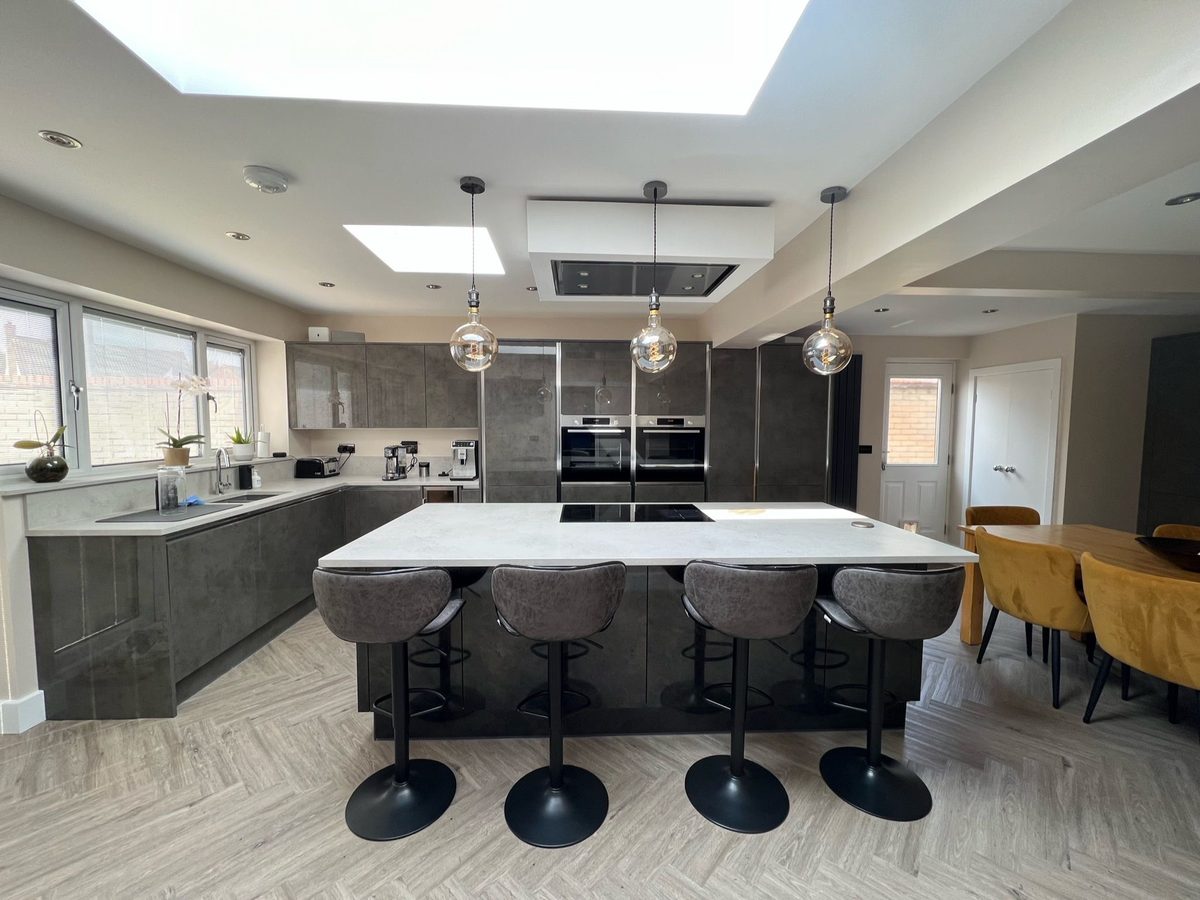 A contemporary kitchen fitted within an extension by A & J Construction