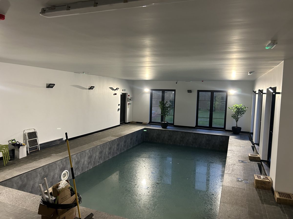 An indoor swimming pool built within a home by A & J Construction