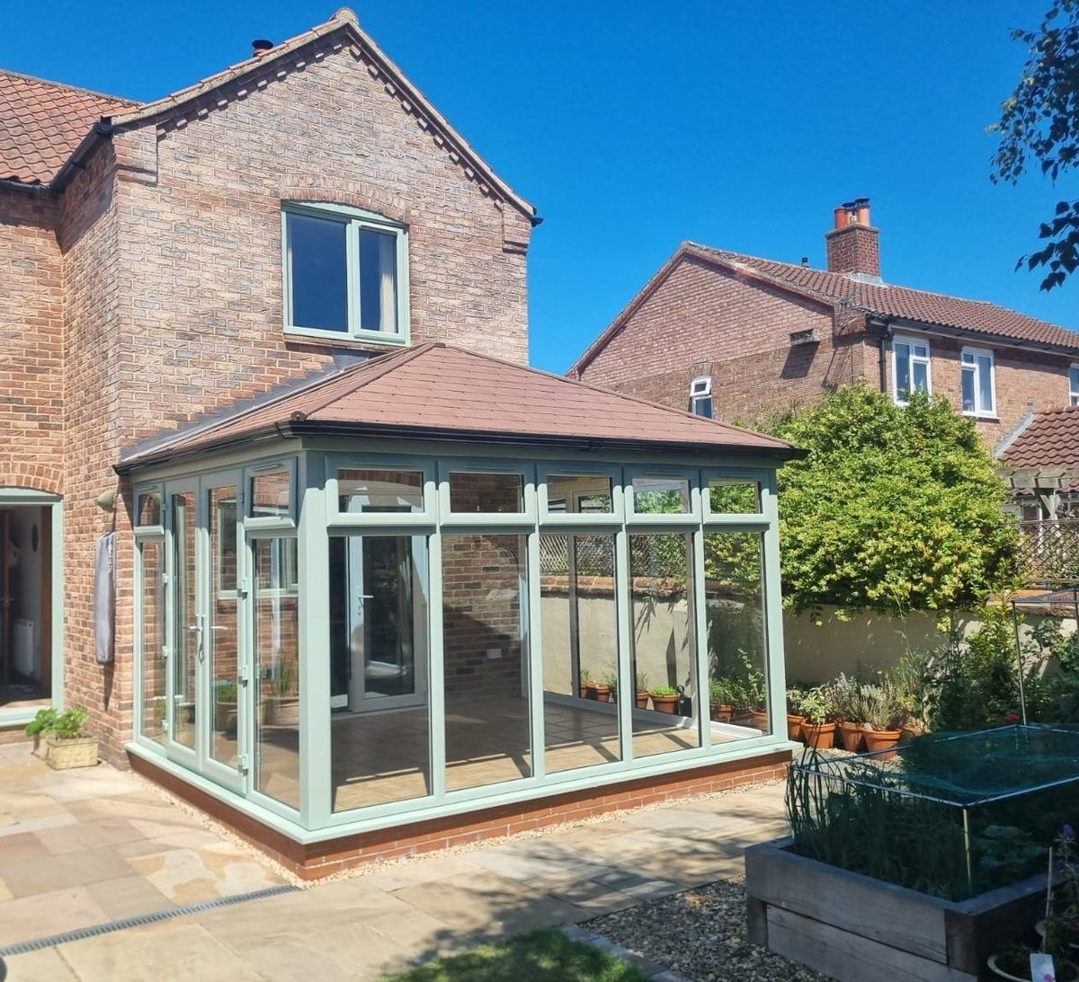 A PVC-U conservatory finished with a solid, energy efficient warm roof, installed by BBH Limited Home Improvements