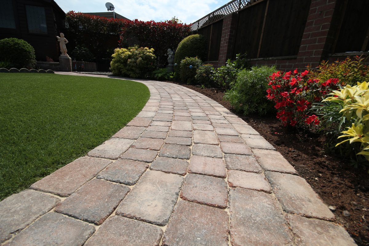 A curved block paved garden pathway with fresh planting, installed by Knights Paving & Landscaping