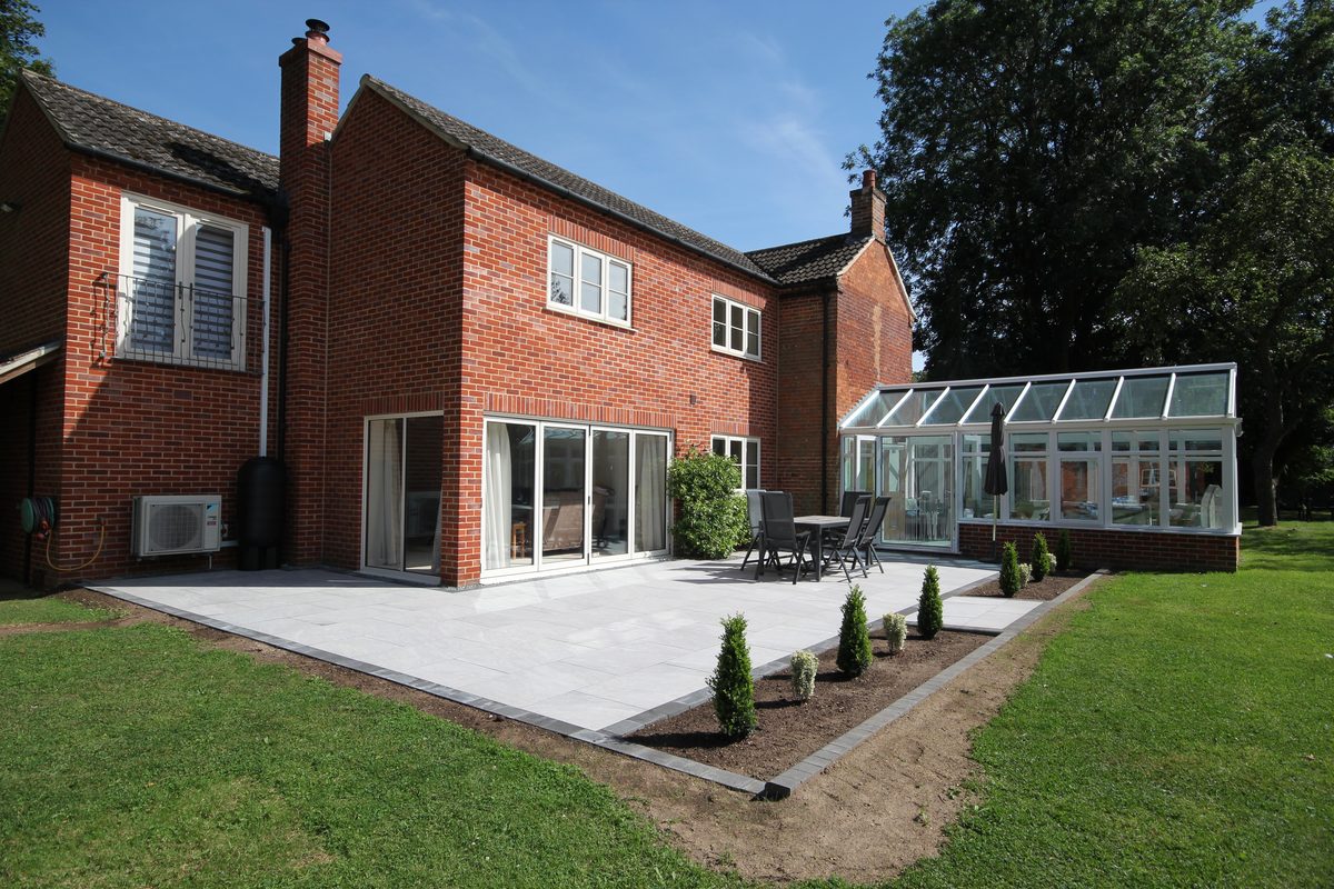 A porcelain patio with charcoal block border and new planting, installed by Knights Paving & Landscaping